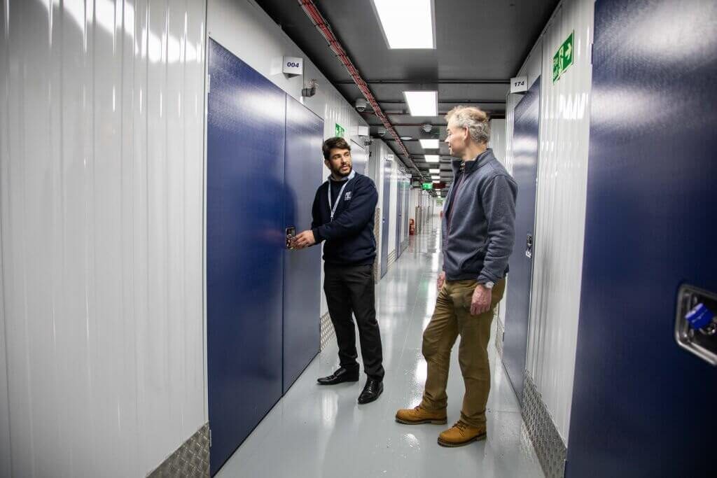A photo of a Vanguard employee taking a customer on a tour of one of our self-storage branches.
