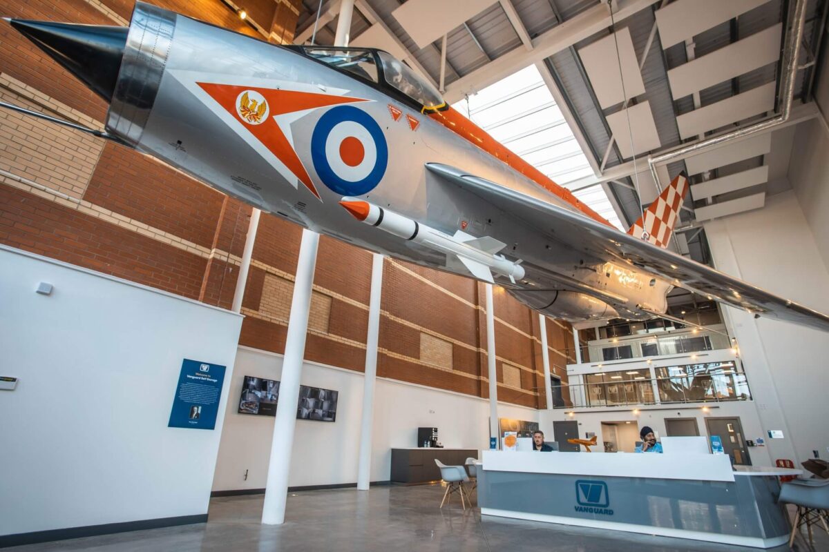 An interior shot of Vanguard's Bristol branch showcasing the fully restored English Electric Lightning fighter jet plane hanging in the reception.