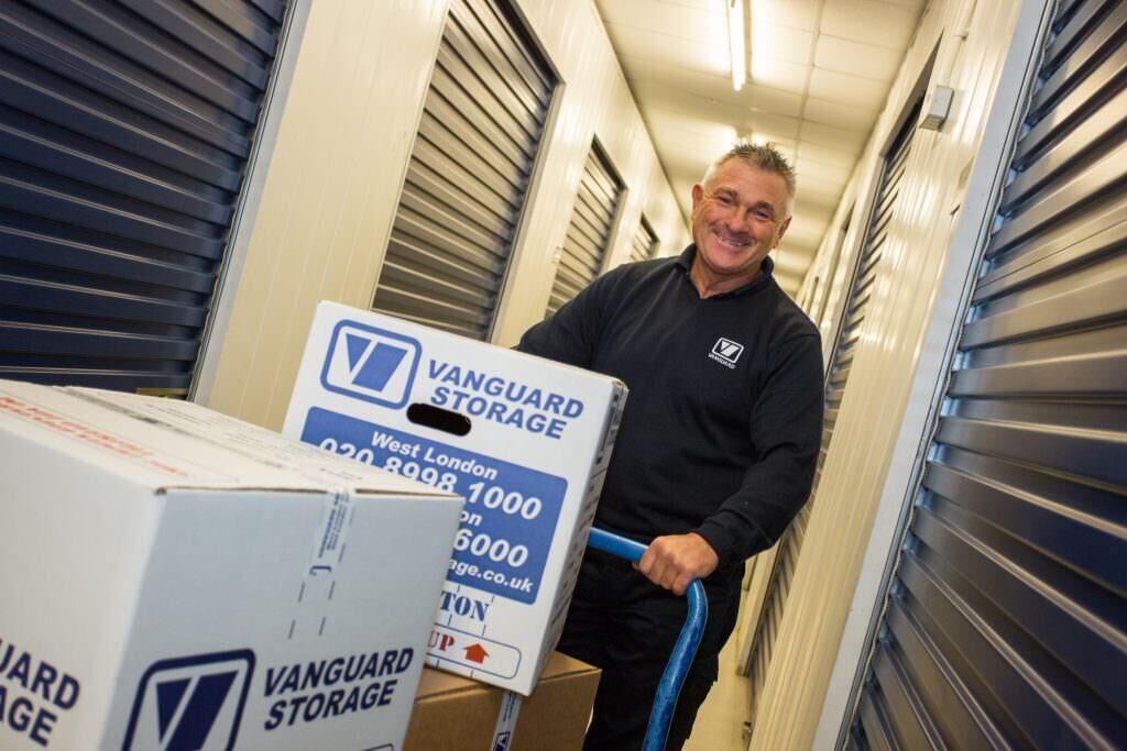 A photo of a Vanguard employee transporting some boxes to a self-storage unit in one of the Vanguard Storage branches.