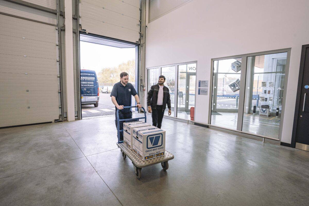 A photo showing a Vanguard employee helping a customer move his boxes into one of the Vanguard Self Storage units.