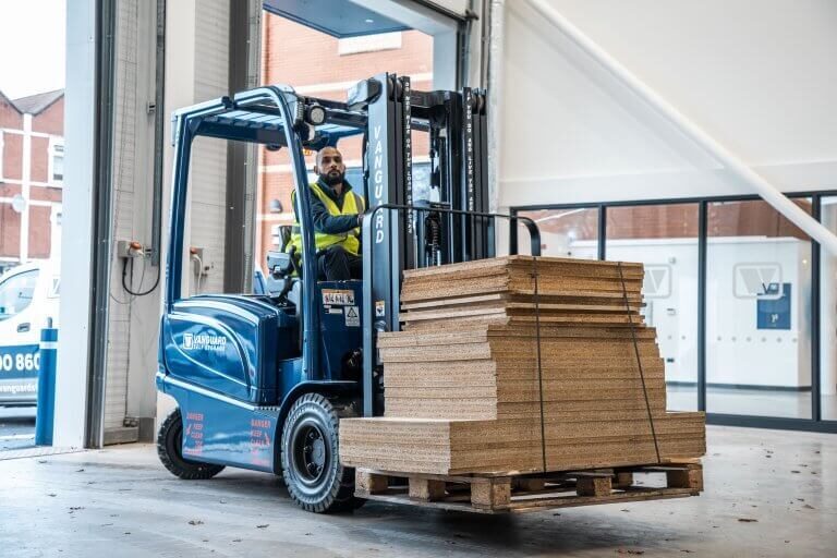 A photo showing a Vanguard employee driving a forklift in one of Vanguard's self storage branches.