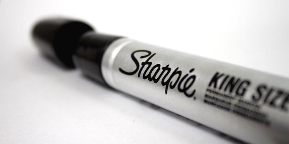 A close-up photo of a permanent Sharpie marker in black.