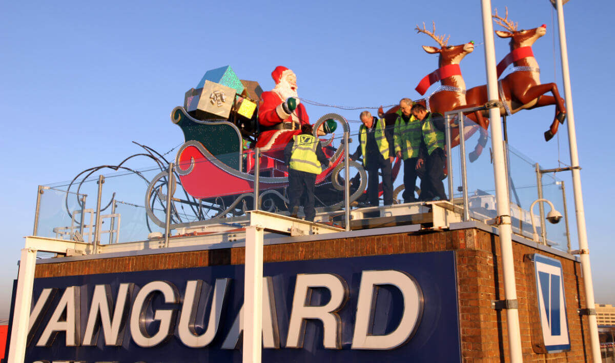 A photo of a giant Santa Claus on top of the roof of Vanguard Self Storage's branch in West London.