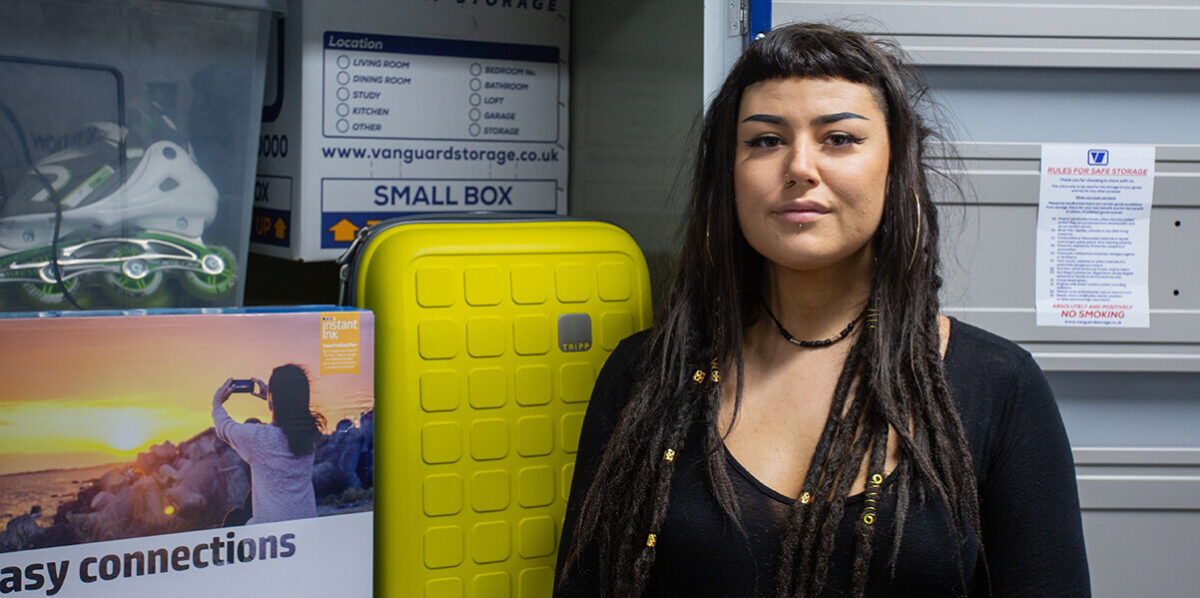 A photo of a customer next to her belongings in one of the Vanguards self-storage units.