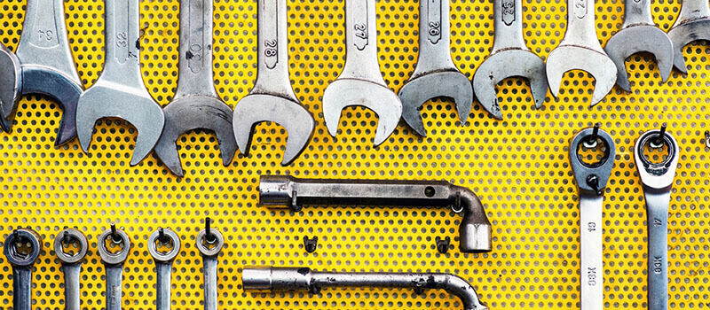 A photo showing a set of tools on a yellow background.