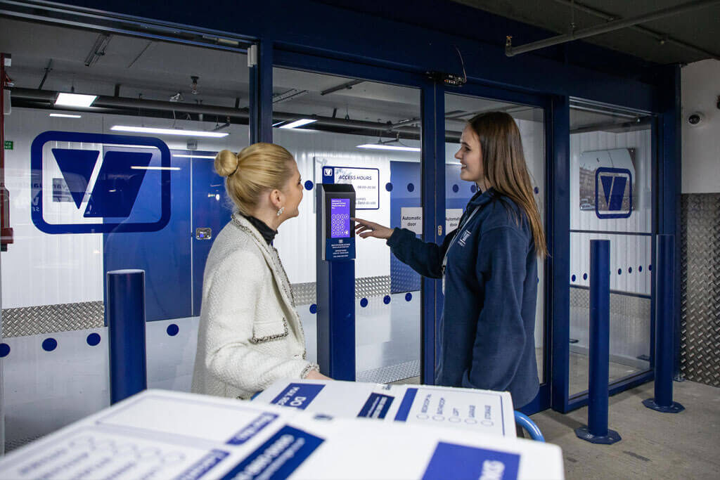 A photo showing a Vanguard employee showing a customer the security measures at one of the Vanguard Self Storage branches.