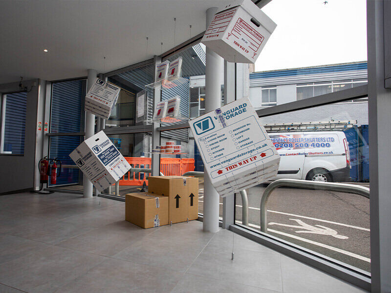 A photo showing cardboard storage boxes hanging from the ceiling in the reception of the Vanguard Self Storage branch in West London.