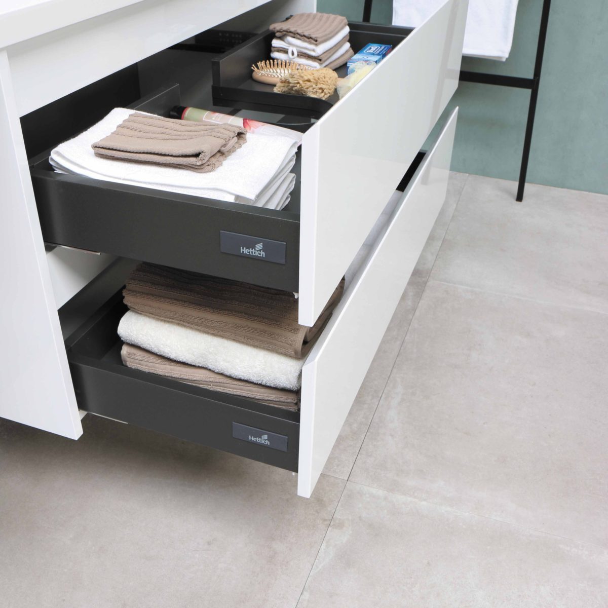 A photo of organised drawers with folded clothes and blankets.