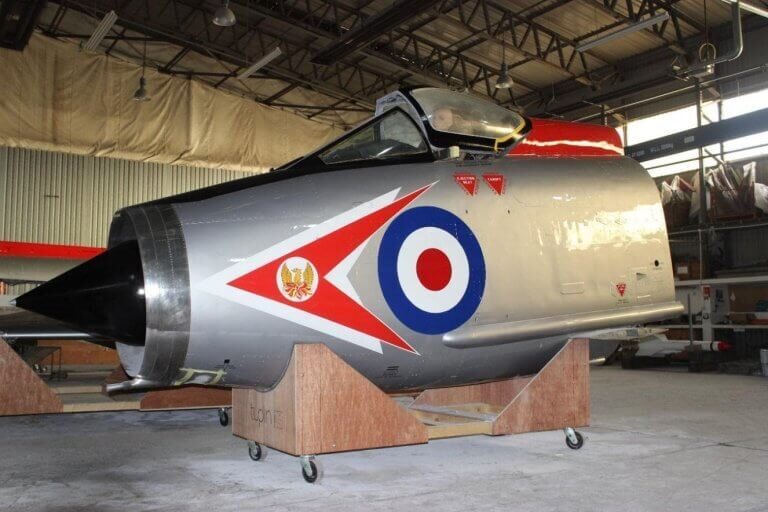 A photo showing the restoration process of the fighter jet hanging in the Vanguard Staples Corner branch.