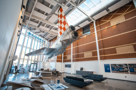 A photo showing the reception of the Vanguard Self Storage branch in Bristol, featuring a fully restored fighter jet hanging from the ceiling.