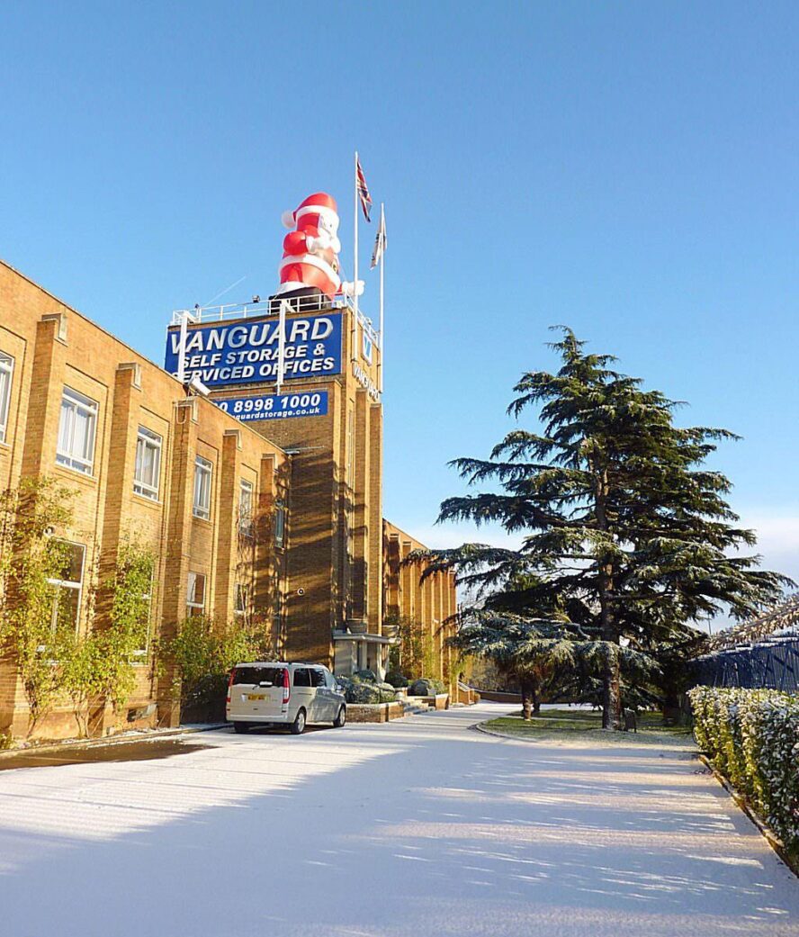 A photo of a giant Santa Claus on top of the roof of Vanguard Self Storage's branch in West London.