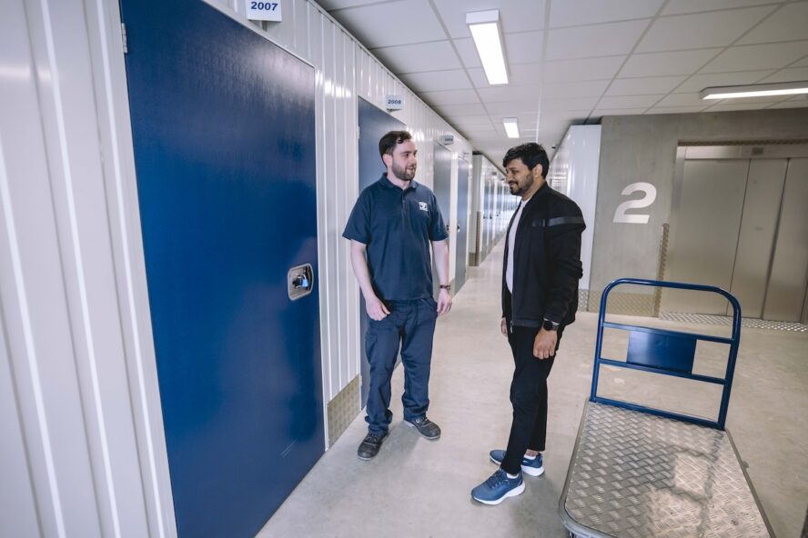 A photo of a Vanguard employee showing a customer around one of Vanguard's self storage branches.