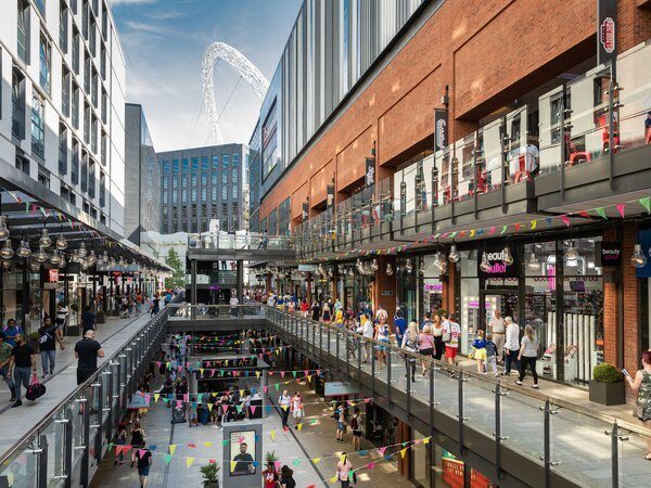 A photo showing the London Designer Outlet in Wembley, with the Wembley Stadium in the background.