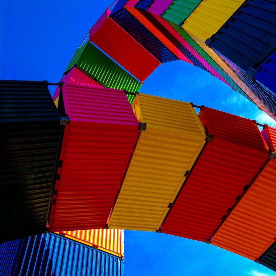 A photo showing colourful storage containers with a clear blue sky.