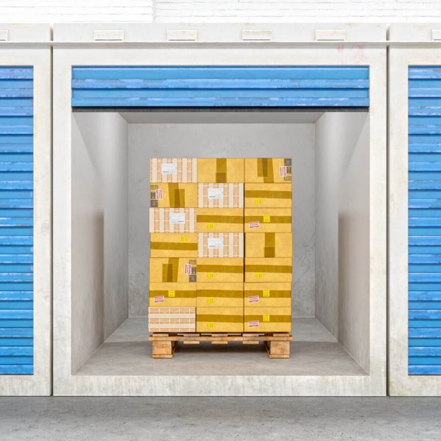 A photo showing a storage unit with a pallet stacked with boxes inside of it.
