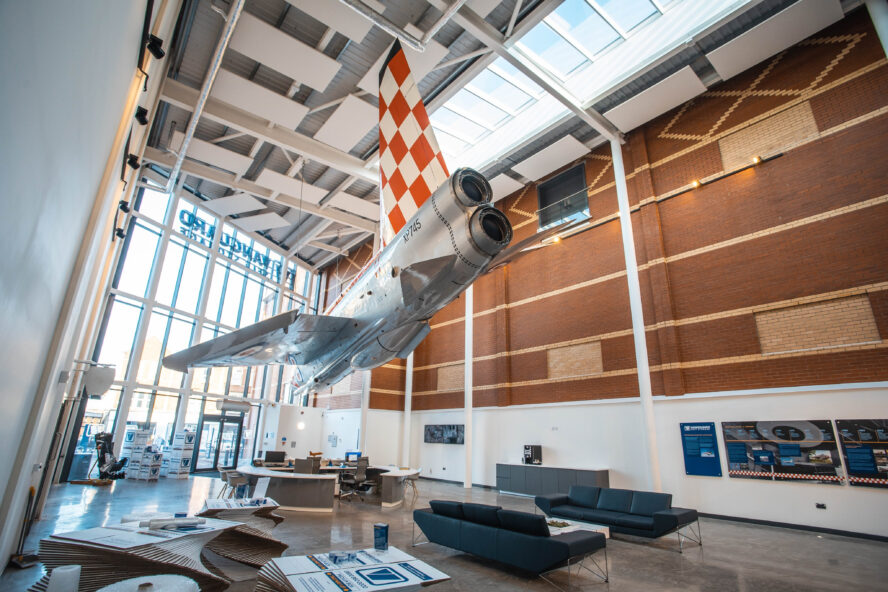 A photo showing the reception of the Vanguard Self Storage branch in Bristol, featuring a fully restored fighter jet hanging from the ceiling.